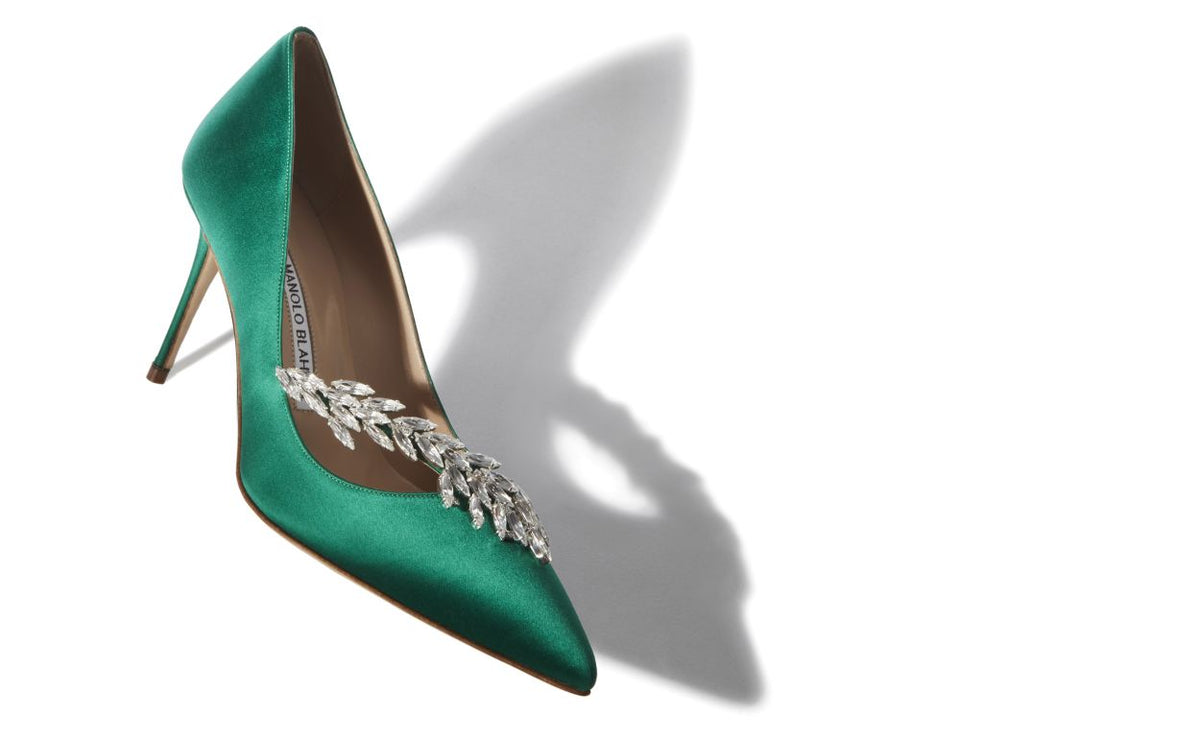 Genevieve Crown Green Jewel Buckle Pumps – front three-quarter view showing green jewel buckle, pointed toe, satin…