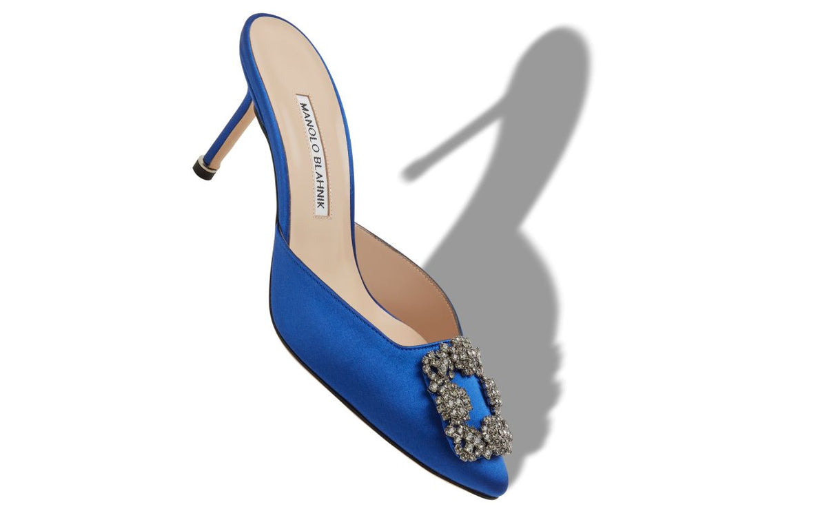 Juliette Crown Blue Jewel Buckle Mules – front three-quarter view showing blue jewel buckle, crystal buckle, almond toe…