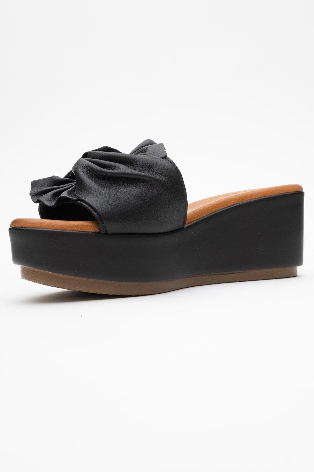 Syndra - Black Bow Wedge Leather Sandal – heel view showing bow, leather, black, Vowalisse