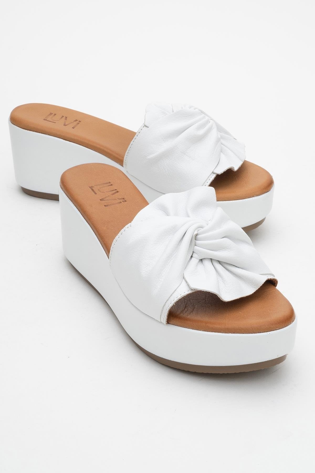 Syndra - White Bow Wedge Leather Sandal – front three-quarter view showing bow, leather, white, Vowalisse