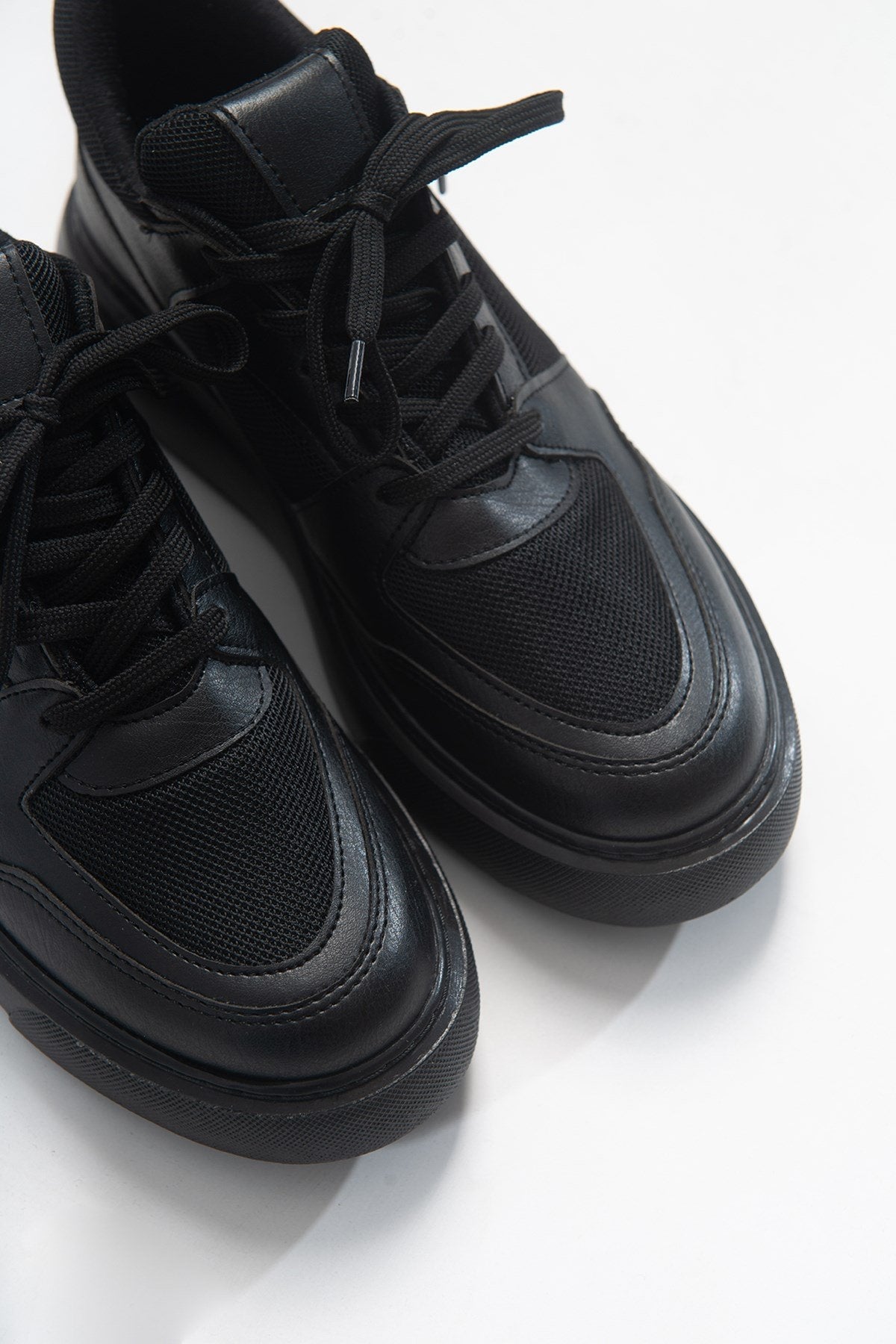 Pure - Black Sneaker – front three-quarter view showing leather, black, Vowalisse