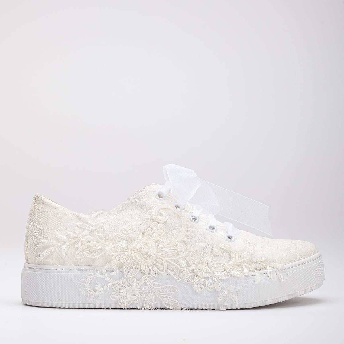 Elise - Ivory Lace Wedding Sneakers – front three-quarter view showing lace, ivory, red, Vowalisse
