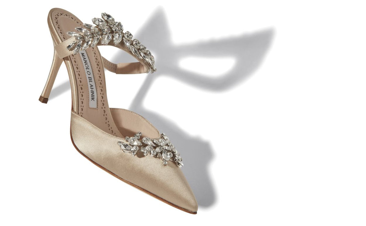 Elara Crown Neutral Crystal Embellished Mules – front three-quarter view showing neutral crystal embellished, pointed toe…