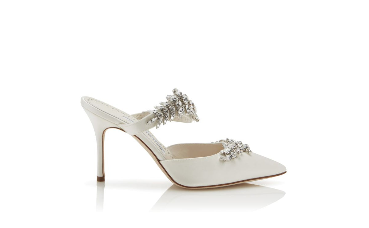 Fiorella Belle White Crystal Embellished Mules – side profile showing white crystal embellished, pointed toe, satin…