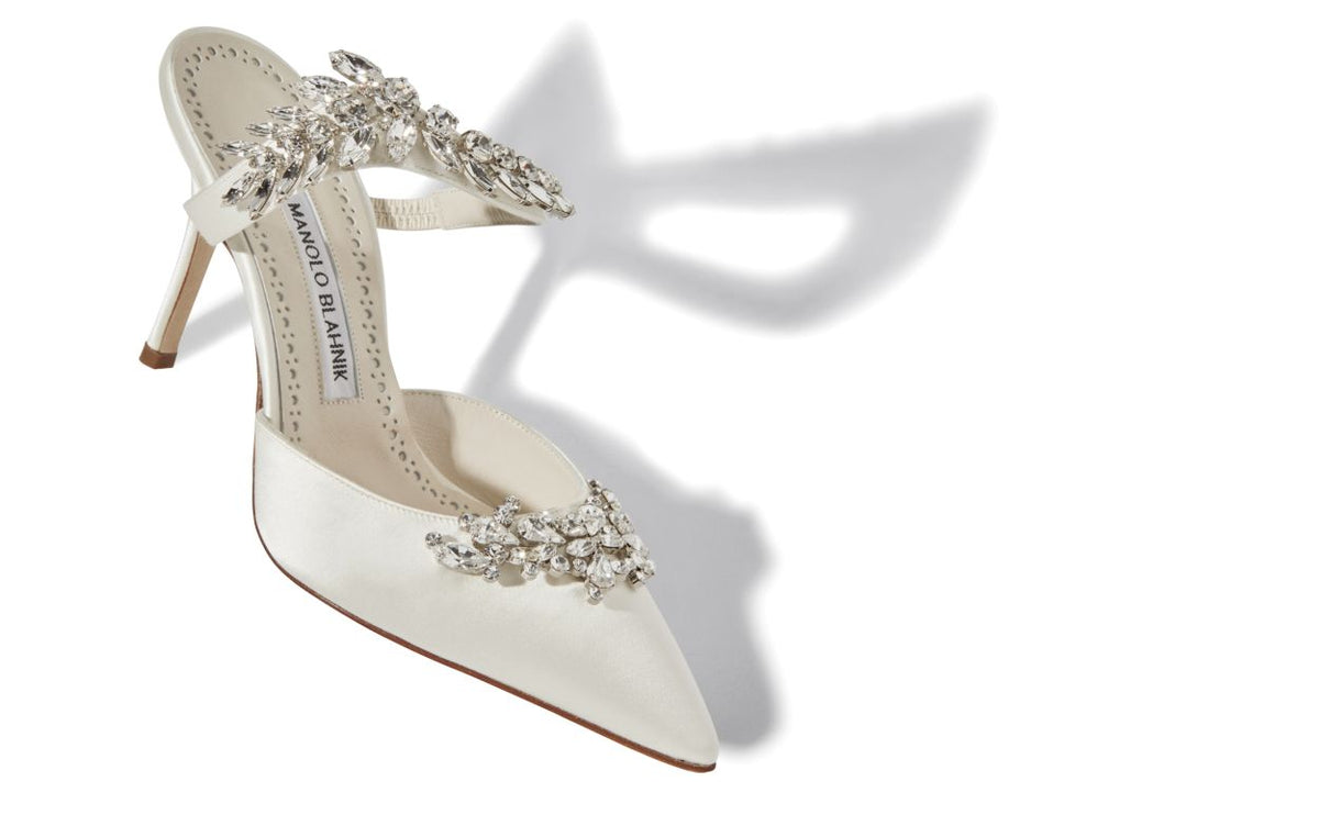 Fiorella Belle White Crystal Embellished Mules – front three-quarter view showing white crystal embellished, pointed toe…