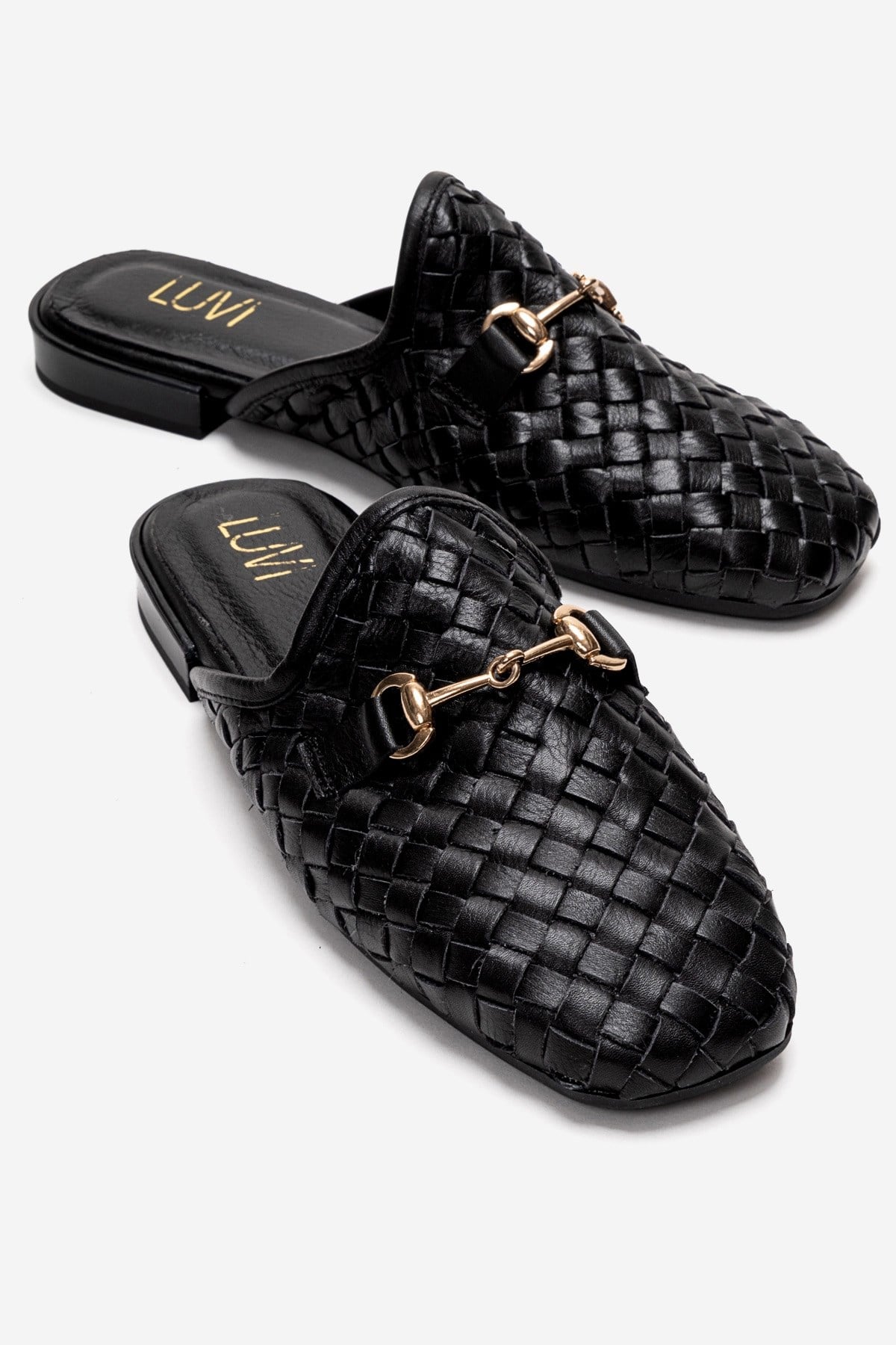SENIA - Black Woven Genuine Leather Buckled Closed-Toe Mule – front three-quarter view showing leather, black, gold…