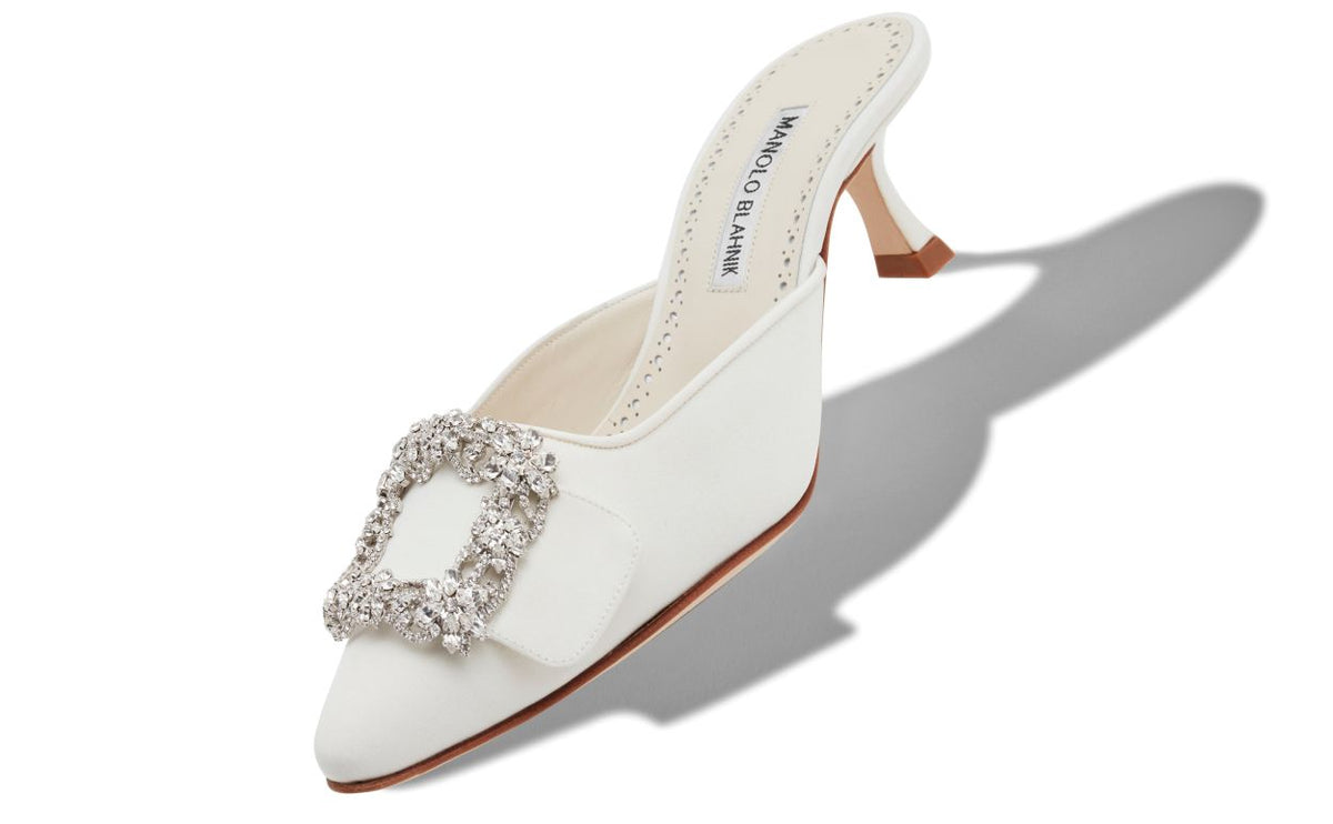 Emmeline Grace White Crystal Buckle Mules – front three-quarter view showing white crystal buckle, pointed toe, satin…