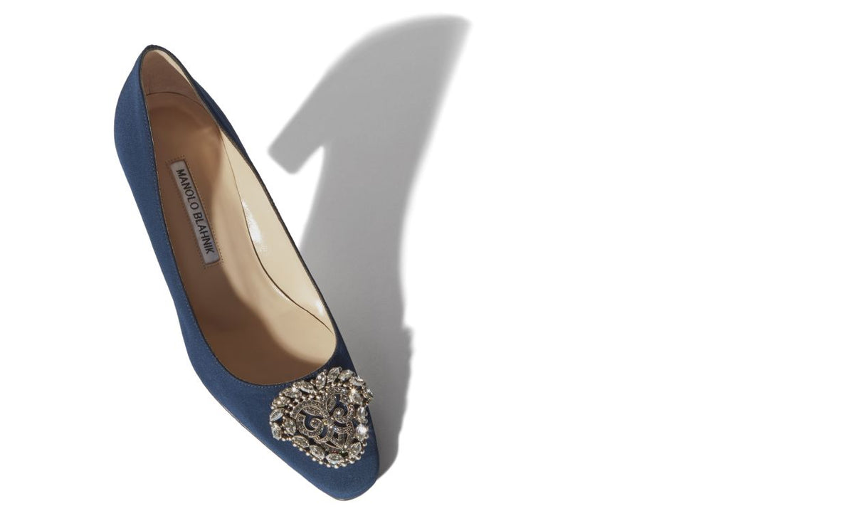 Celeste Élan Blue Jewel Buckle Pumps – front three-quarter view showing blue jewel buckle, crystal buckle, almond toe…