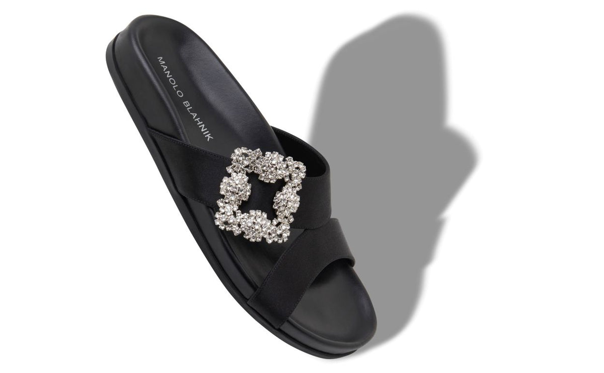Adriana Grace Black Jewel Buckle Mules – front three-quarter view showing black jewel buckle, crossover, open toe, satin…