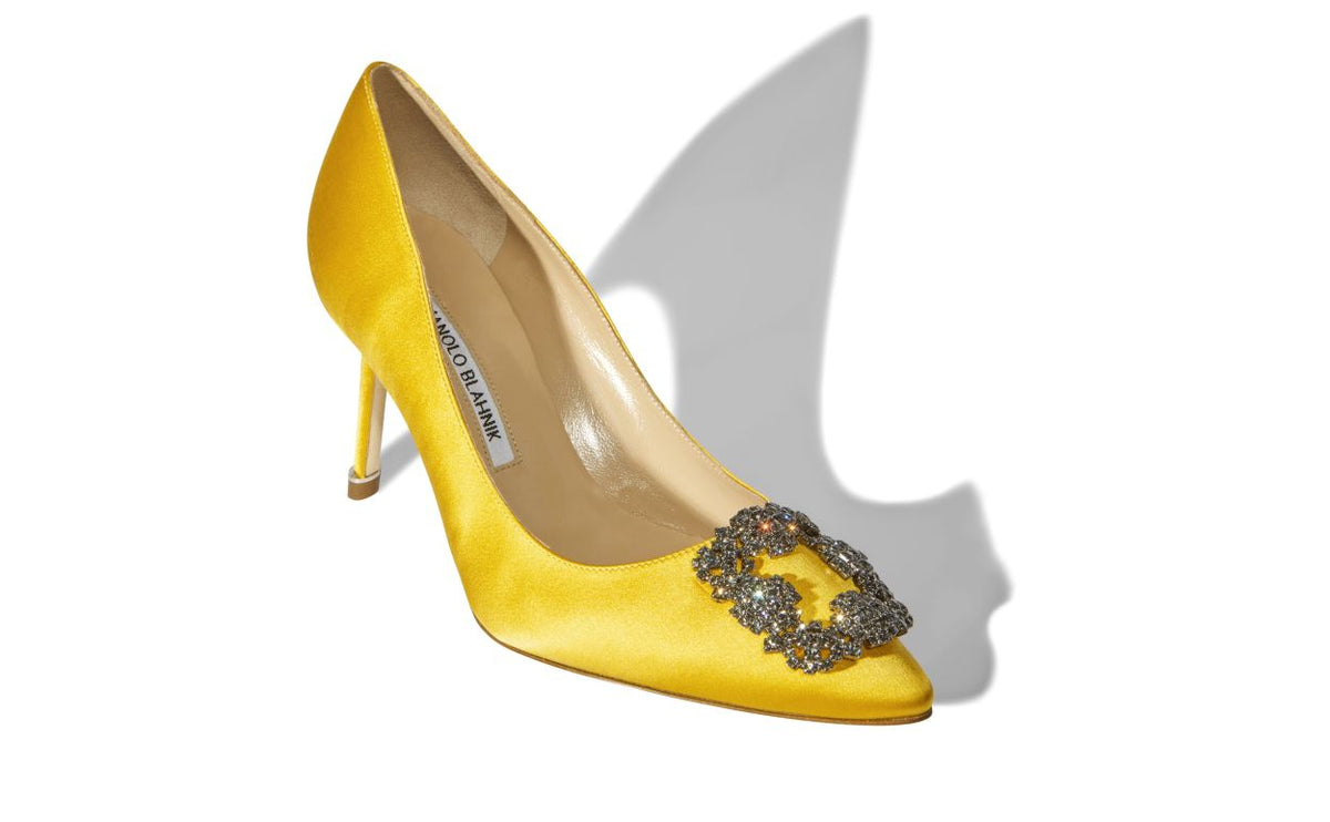 Adriana Bloom Yellow Jewel Buckle Pumps – front three-quarter view showing yellow jewel buckle, crystal buckle, almond toe…
