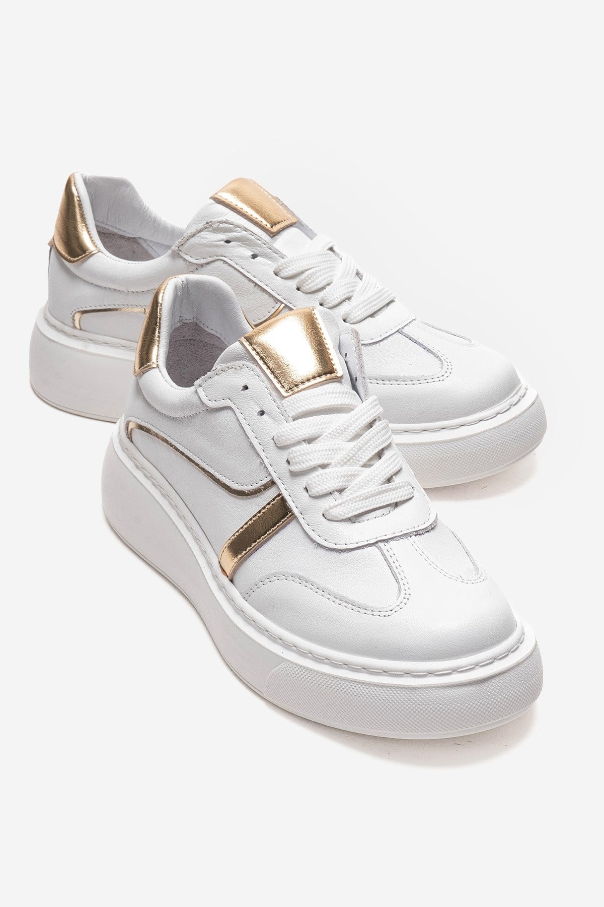 IVARA - White And Gold Genuine Leather Everyday Sneaker – front three-quarter view showing leather, metallic, white…